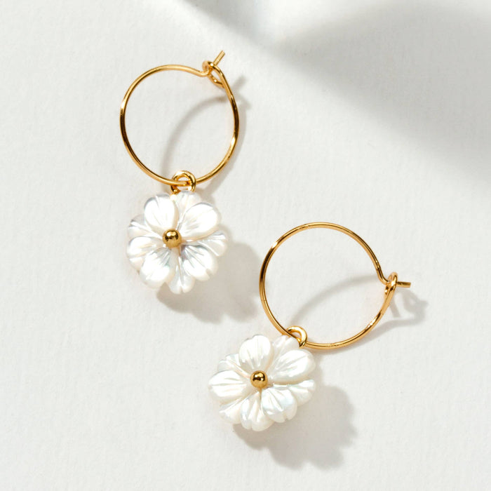 Luna Norte blooming hoop earrings featuring floral design and gold-tone finish, elegantly displayed on a white background.