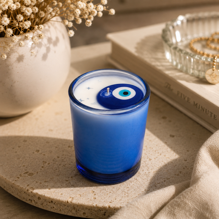 Private label evil eye votive soy candle with decorative design, small candle in a clear glass holder.