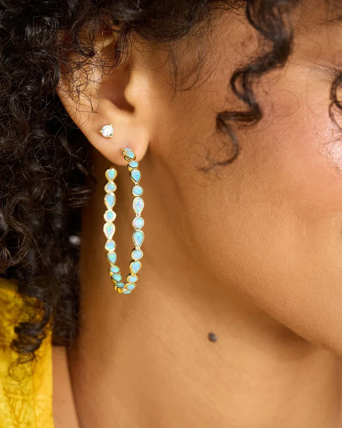 Melinda Maria Isla Hoops 2-inch gold earrings with a sleek, minimalist hoop design.