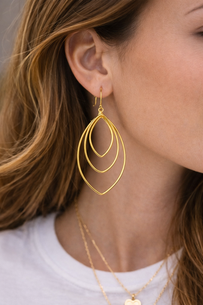 Leafy earrings by Private Label featuring intricate leaf designs in a stylish gold finish.