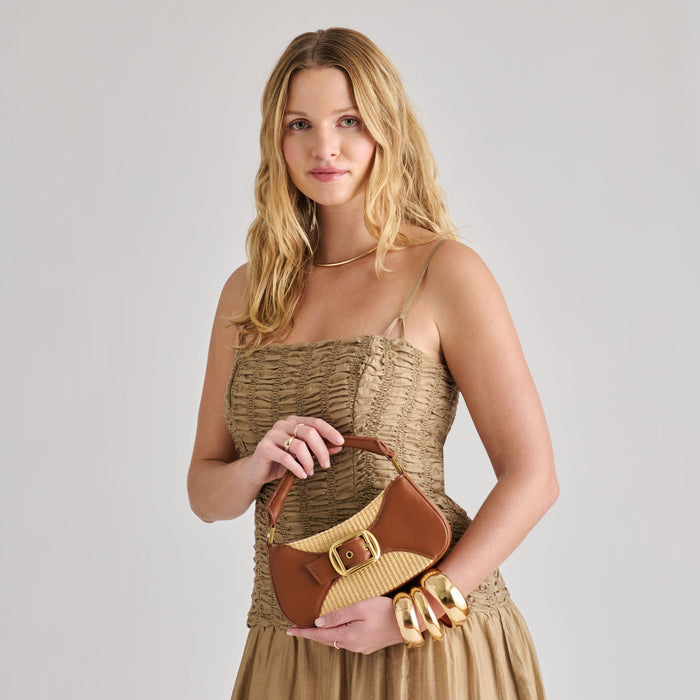 Dolce Vita Nuala-R top handle bag with sleek design and structured shape, featuring a stylish leather finish.