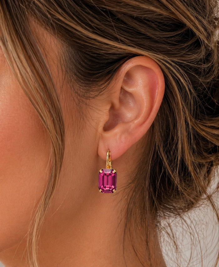 Sorrelli Octavia dangle earrings featuring intricate metalwork and sparkling gemstone accents, hanging elegantly.