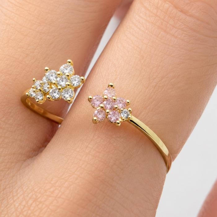 Private label open flower ring with intricate petal design, silver-toned jewelry piece on a white background.
