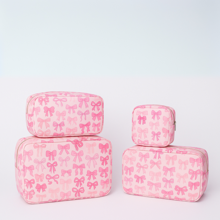 Pink nylon bow makeup bag by Lil Darlings featuring a cute bow design and spacious interior for cosmetics.