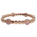 Pink stackable bracelet with dottie and smiley charms by la lumiere ny, showcasing a playful and colorful design.