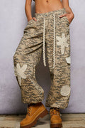 Pol Clothing pleat detail floral patchwork cargo pants featuring pleats, floral patches, and a relaxed fit for casual style.