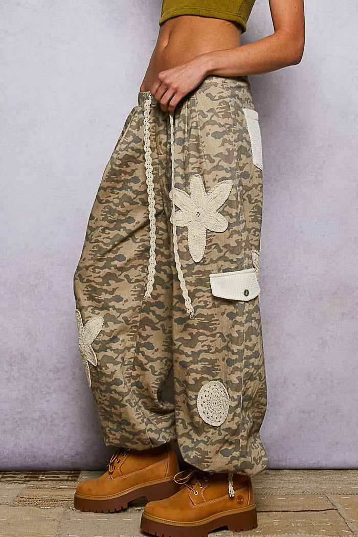 Pol Clothing pleat detail floral patchwork cargo pants showing vibrant floral patches and pleated design on casual pants.