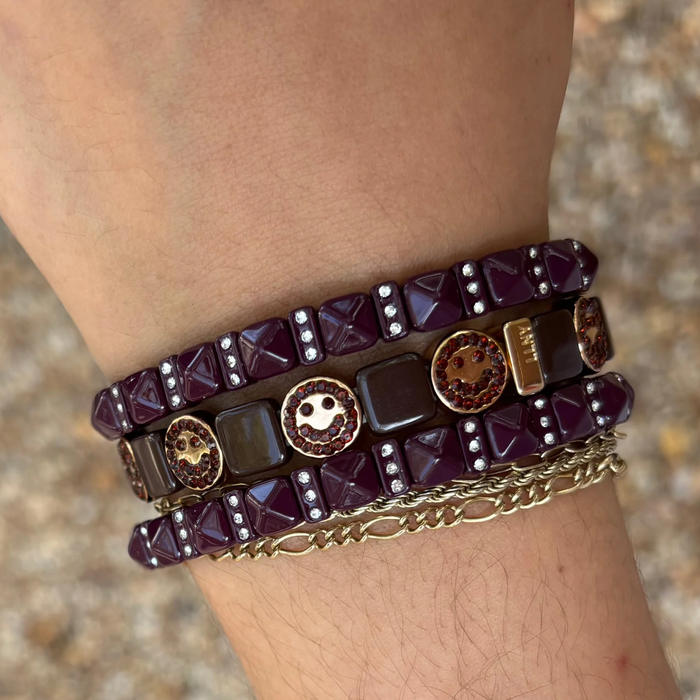 Plum studded gem bracelet by la lumiere ny, featuring colorful gems and a stylish design on a delicate band.