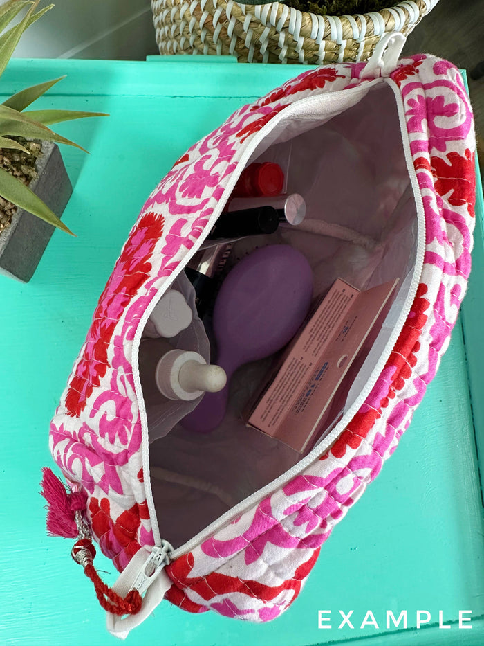 White quilted Folklore Couture cosmetics pouch with cherries and bows, featuring a stylish, padded makeup bag design.