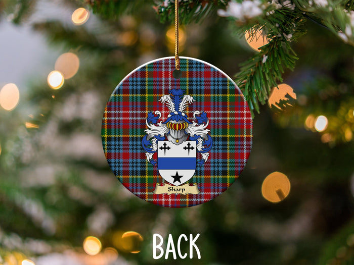Sharp ceramic ornament detail showing a double-sided family shield on a Caledonia tartan background
