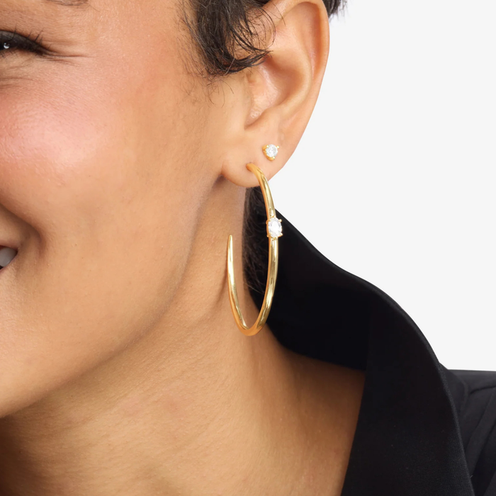 Melinda Maria She's on Point Hoops 2-inch silver earrings with a sleek, modern design for stylish wear.