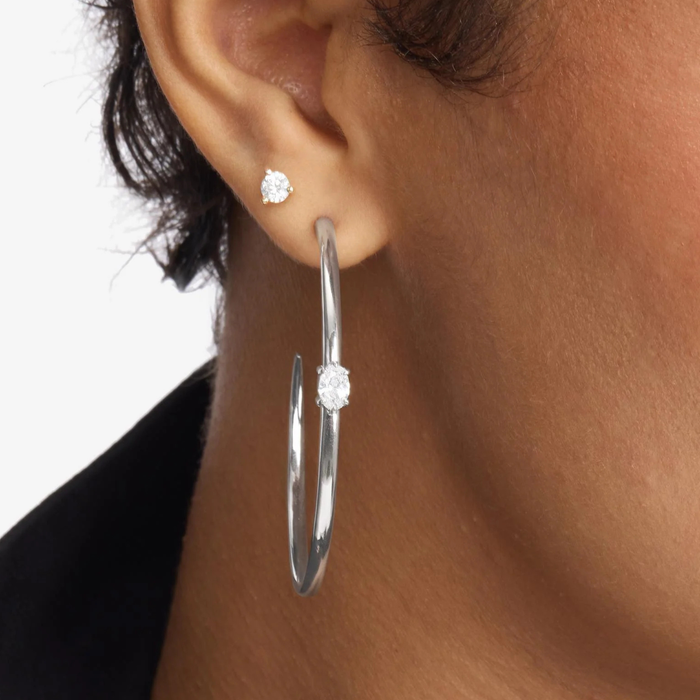 Melinda Maria She's on Point Hoops 2-inch gold earrings with a sleek, modern hoop design and polished finish.
