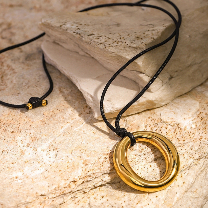 Simple round cutout titanium necklace with sleek design, featuring a minimalist look and polished finish.