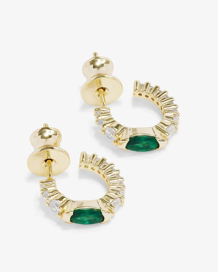 Gold hoop earrings called The Maven Huggies by Melinda Maria, featuring a sleek, minimalist design for everyday wear.