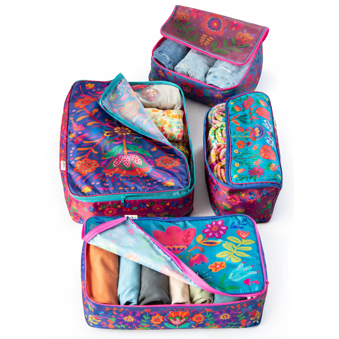Set of four Natural Life Travel Packing Cubes with colorful folk flower patterns, ideal for organizing clothes during travel.