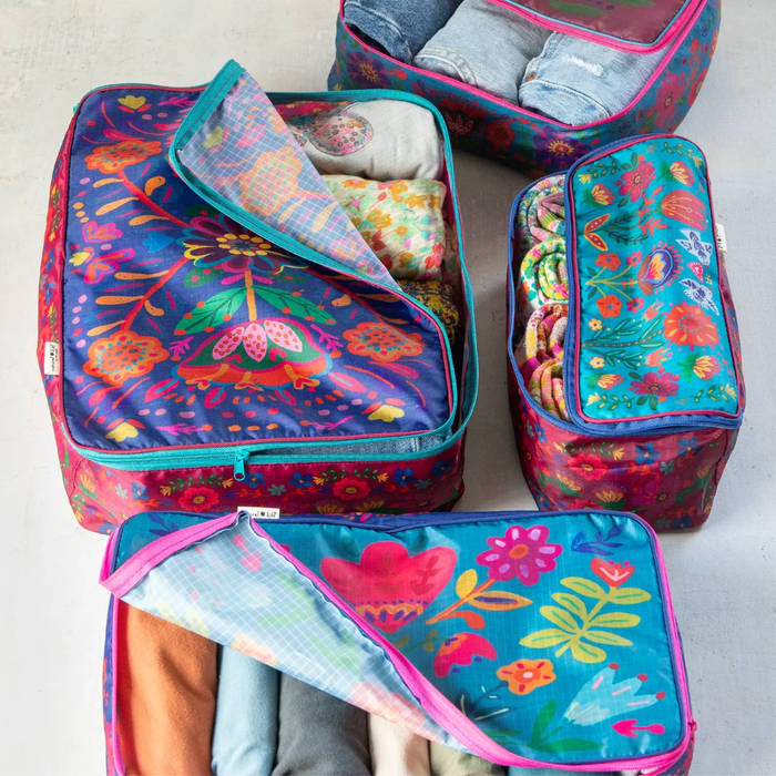 Natural Life travel packing cubes set of 4 featuring colorful folk flower patterns, lightweight pouches for organized packing.