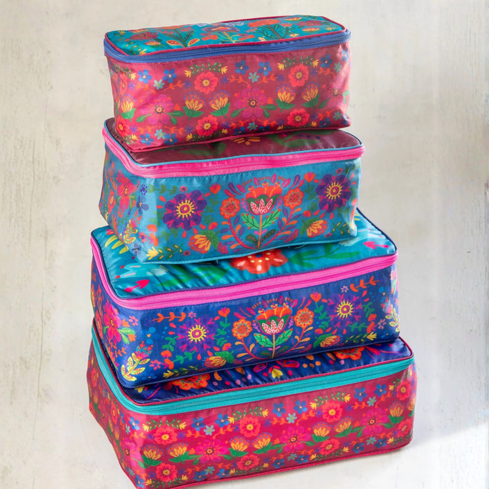 Set of four Natural Life travel packing cubes with colorful folk flower patterns, ideal for organizing clothing and accessories.