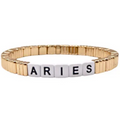 Gold stackable bracelet featuring zodiac sign charms by la lumiere ny on a neutral background.